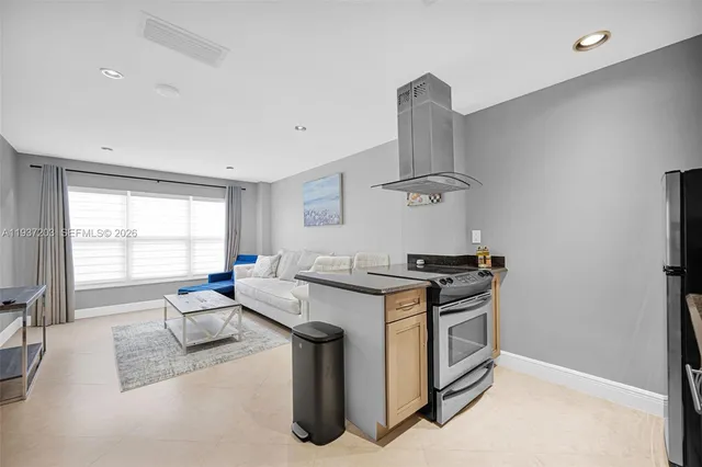 a kitchen with stainless steel appliances granite countertop a stove and a sink