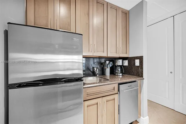 a kitchen with a refrigerator and cabinets
