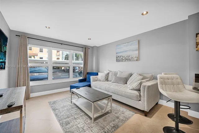 a living room with furniture and a large window