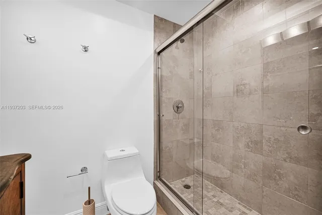 a bathroom with a toilet and a shower