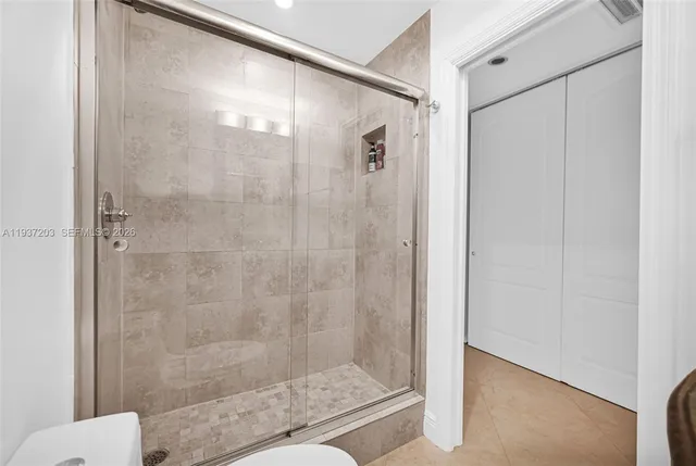 a bathroom with a shower and a sink
