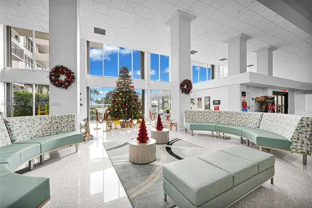 a living room with furniture and kitchen view