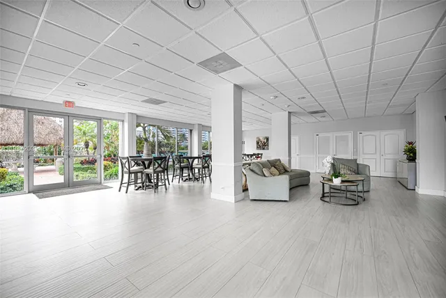 a living room with furniture and a large window with outer view