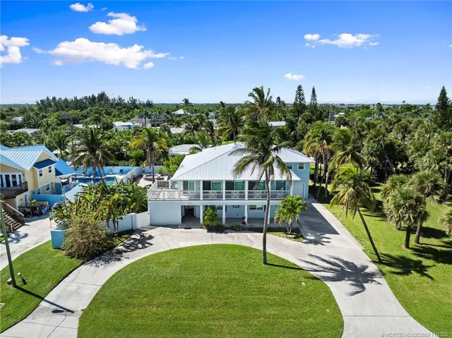 a view of a house with swimming pool and sitting area