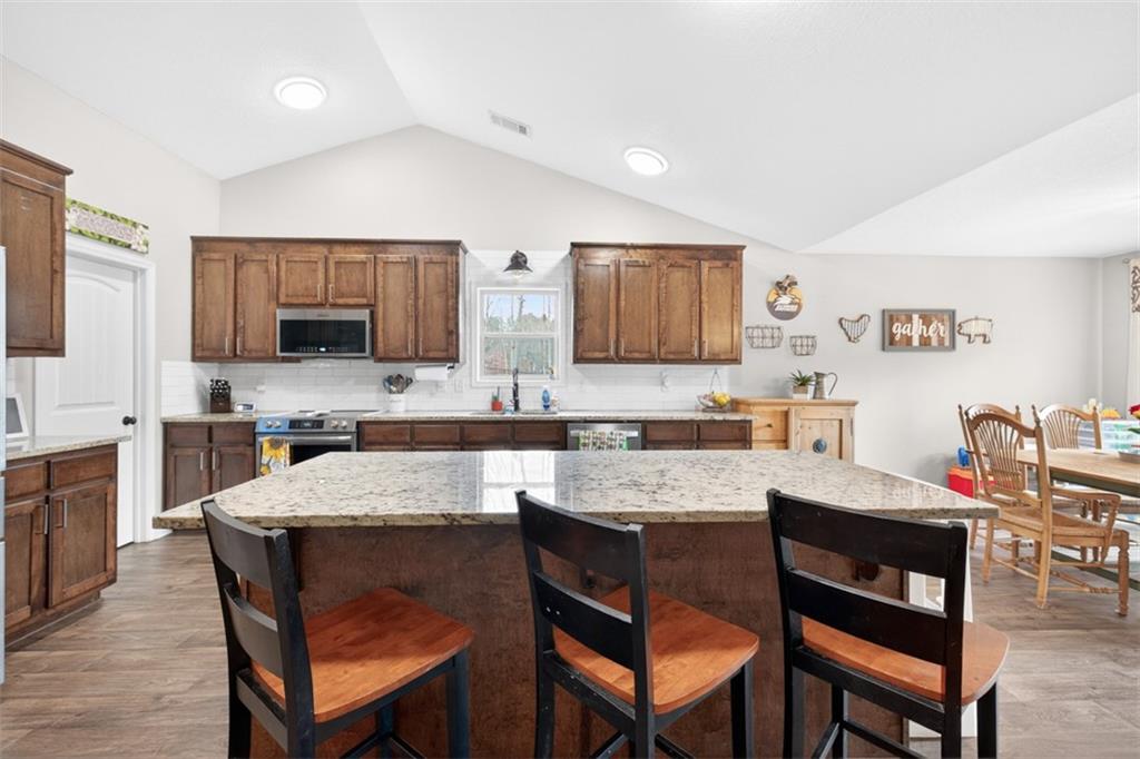 225 Tyler Way Jefferson, GA 30549 - Photo 18 of 43 a view of kitchen with granite countertop cabinets table and chairs