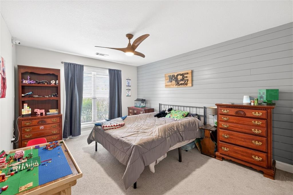 225 Tyler Way Jefferson, GA 30549 - Photo 21 of 43 a bed room with a bed dresser and a chair