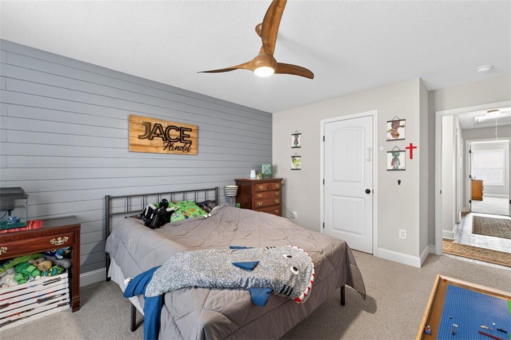 225 Tyler Way Jefferson, GA 30549 - Photo 22 of 43 a bedroom with a bed and a table in it