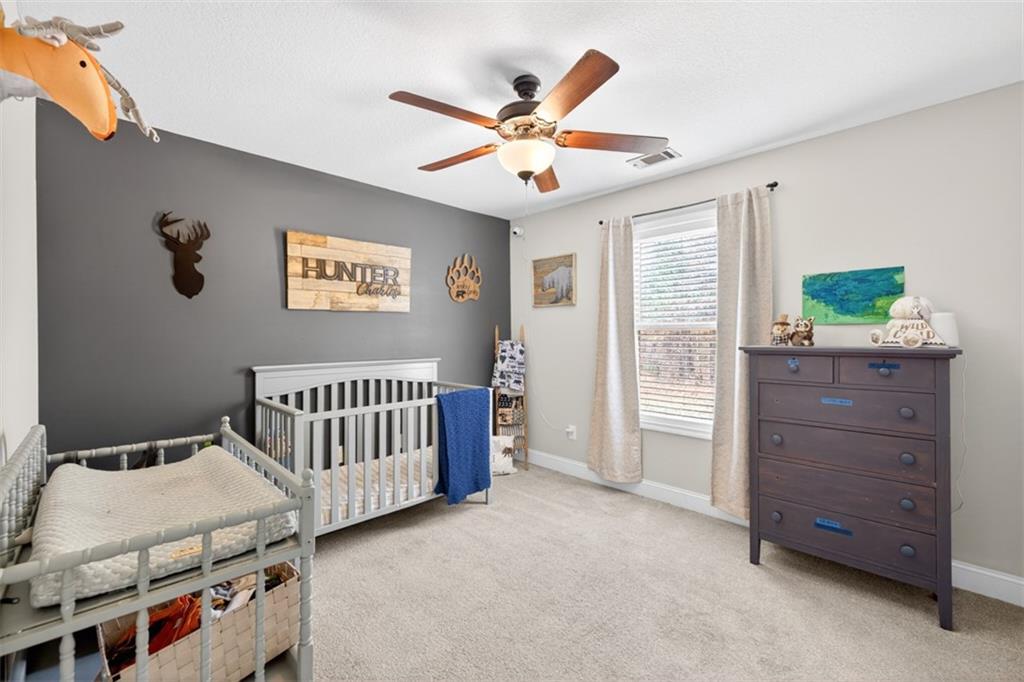 225 Tyler Way Jefferson, GA 30549 - Photo 25 of 43 a bedroom with a bed and a window