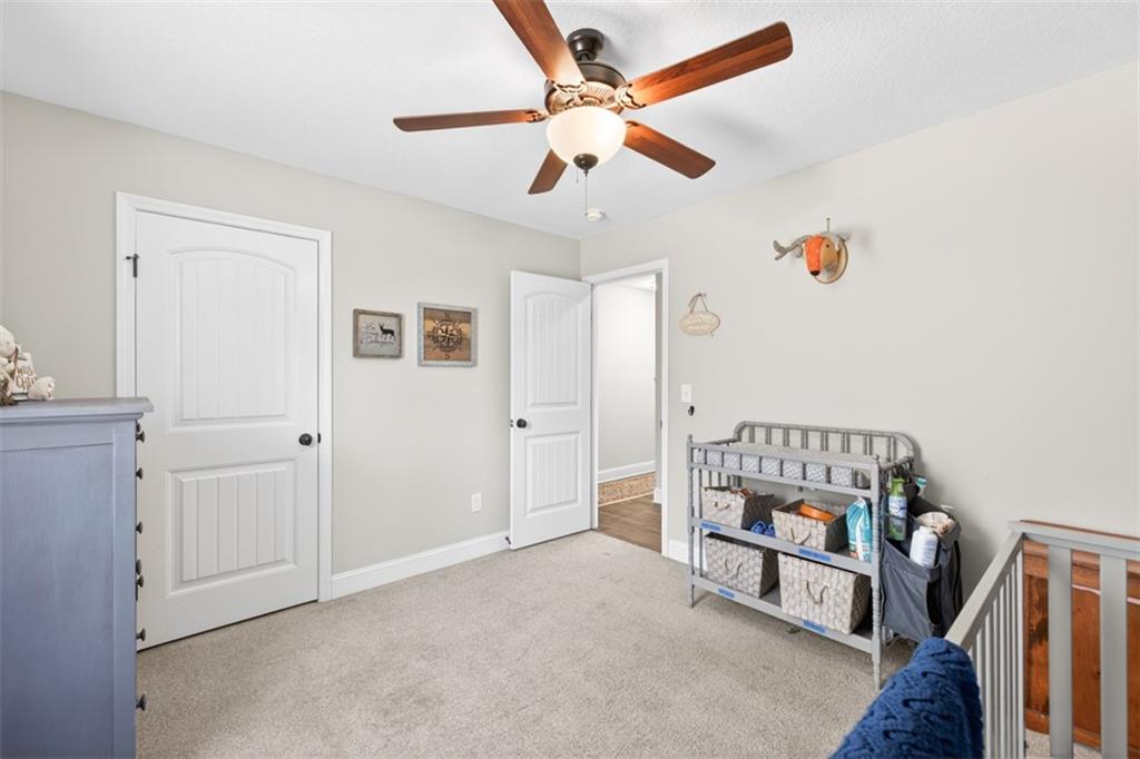 225 Tyler Way Jefferson, GA 30549 - Photo 26 of 43 an empty room with windows and ceiling fan