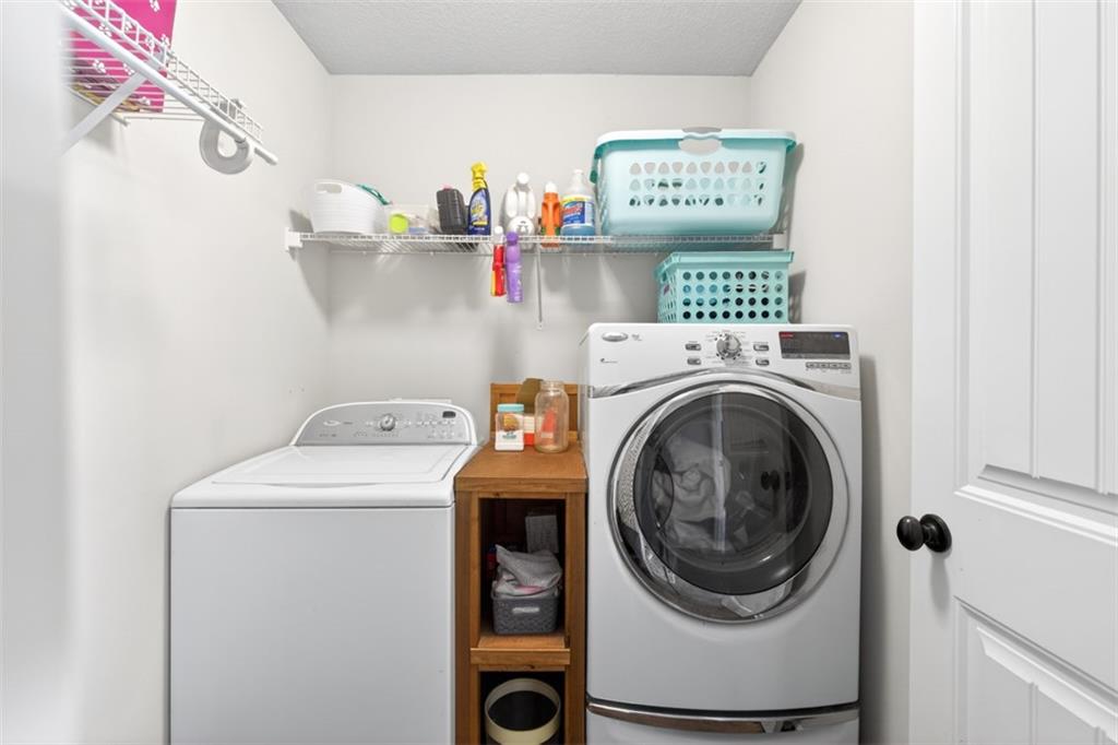 225 Tyler Way Jefferson, GA 30549 - Photo 28 of 43 a view of washer and dryer with kitchen in the background