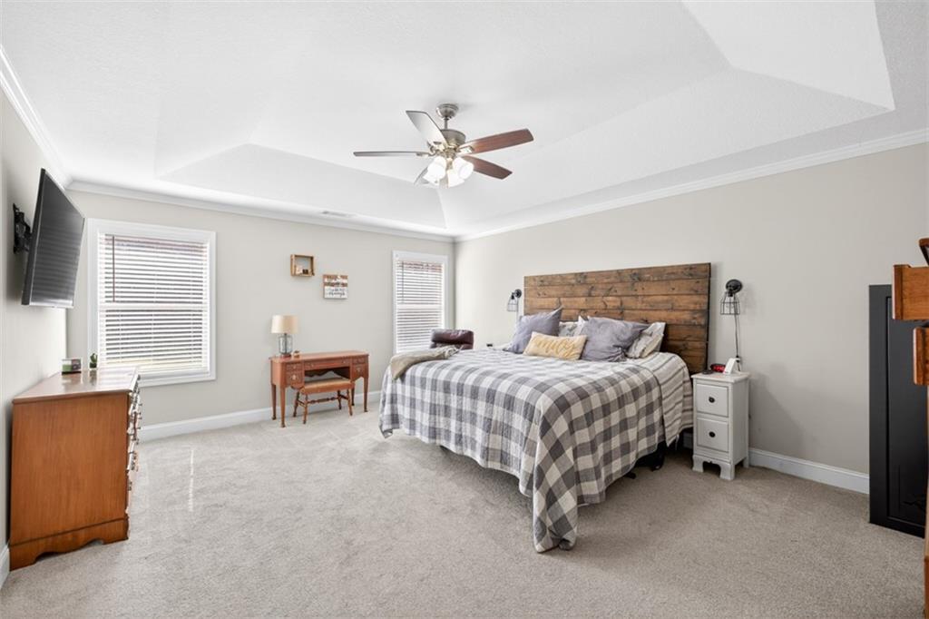 225 Tyler Way Jefferson, GA 30549 - Photo 29 of 43 a bedroom with a bed and a chandelier