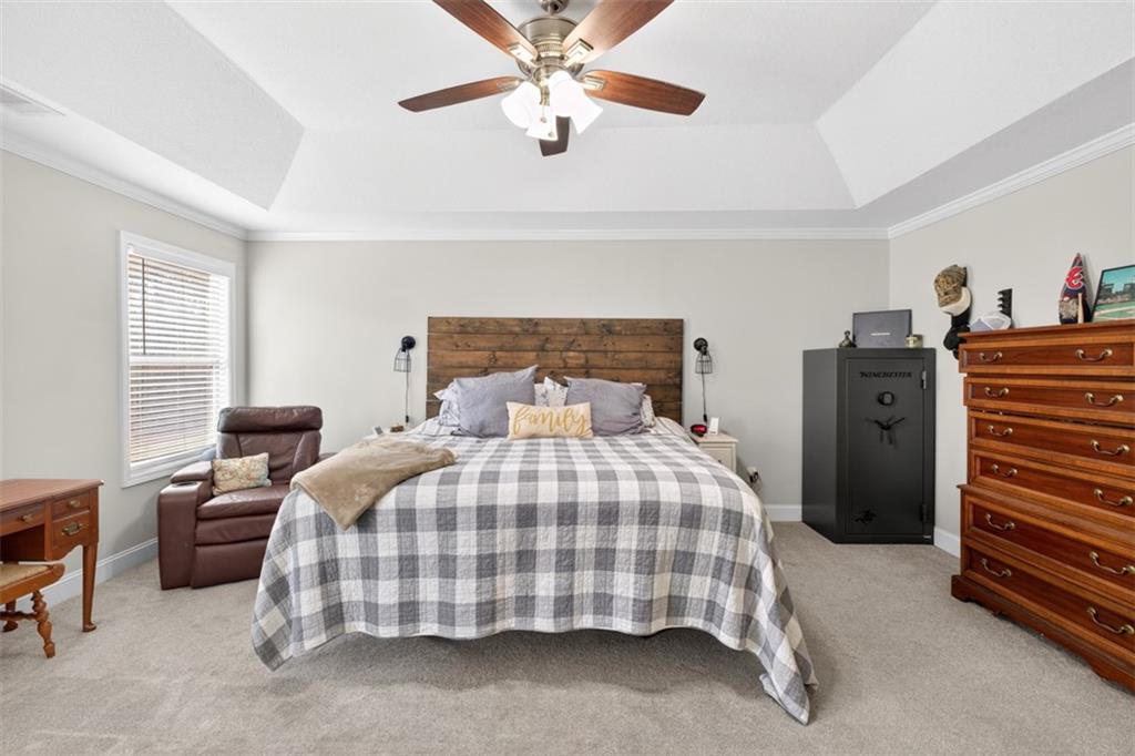 225 Tyler Way Jefferson, GA 30549 - Photo 30 of 43 a bedroom with a bed and a chandelier