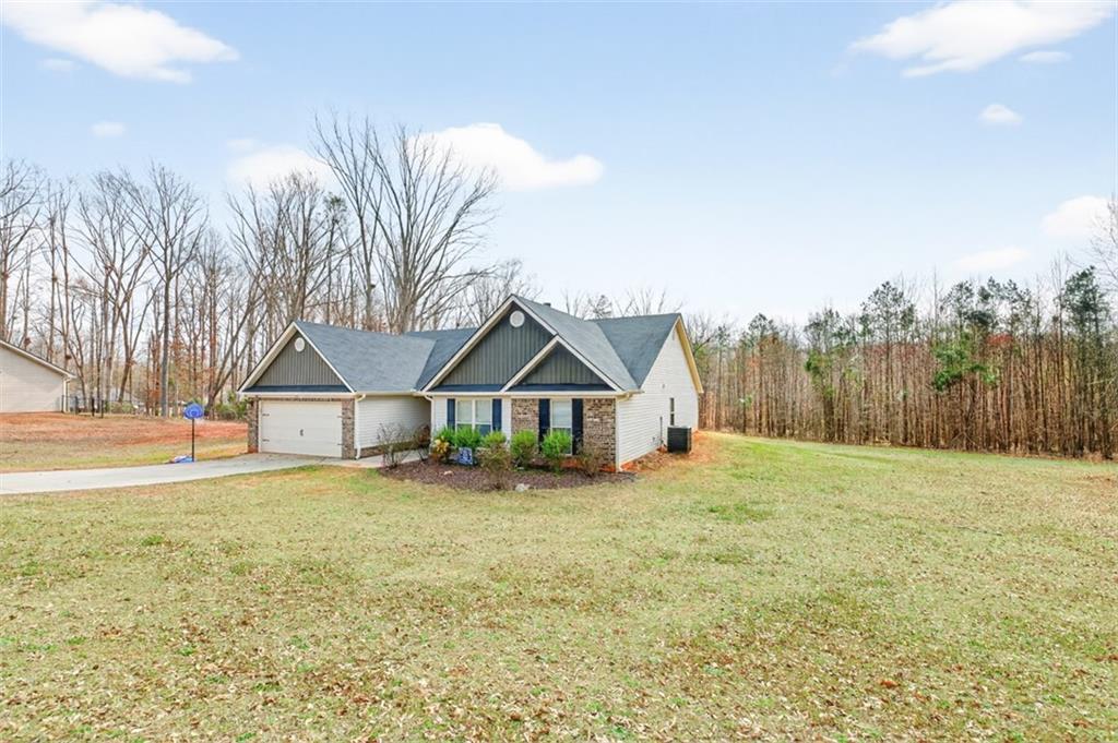225 Tyler Way Jefferson, GA 30549 - Photo 3 of 43 a house with trees in the background