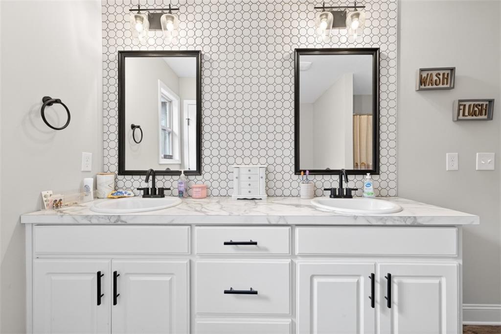 225 Tyler Way Jefferson, GA 30549 - Photo 35 of 43 a bathroom with double vanity sinks and a mirror