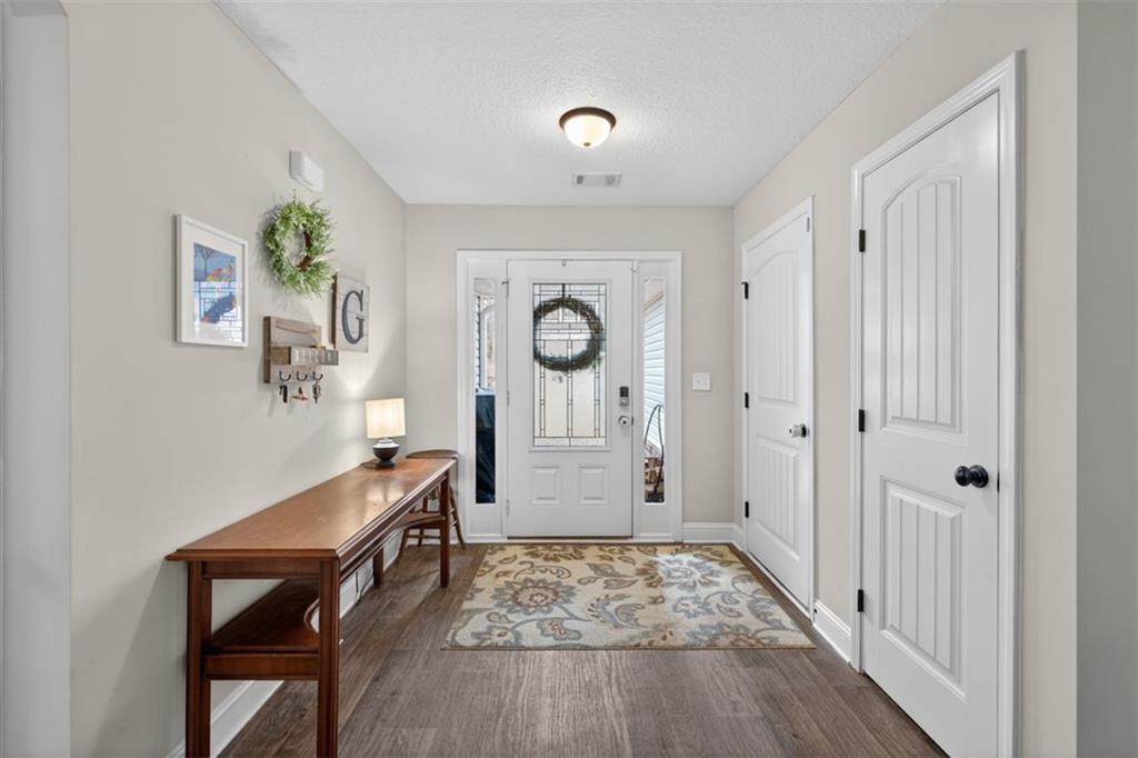 225 Tyler Way Jefferson, GA 30549 - Photo 6 of 43 a view of a hallway with entryway wooden floor and front door