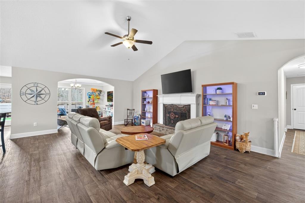 225 Tyler Way Jefferson, GA 30549 - Photo 10 of 43 a living room with furniture a fireplace and a flat screen tv