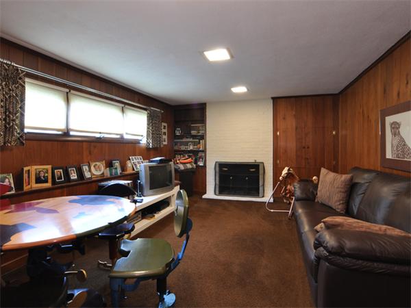 55 Gary Road Needham, MA 02494 - Photo 6 of 30 a living room with furniture a flat screen tv and outdoor view