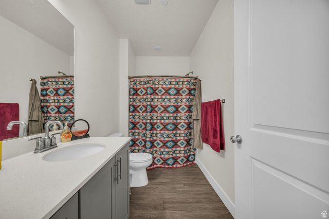 2101 North Main Street, Unit 409 Sunset, UT 84015 - Photo 12 of 18 Full bath with vanity, curtained shower, and dark wood-style flooring
