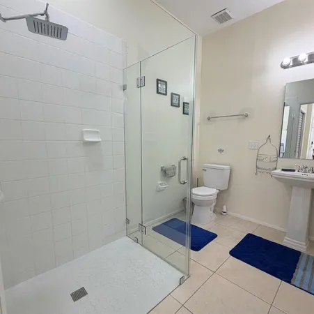 a bathroom with a toilet and a shower