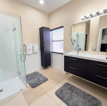 a spacious bathroom with a tub sink and a mirror