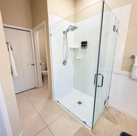 a bathroom with a glass shower door and a sink