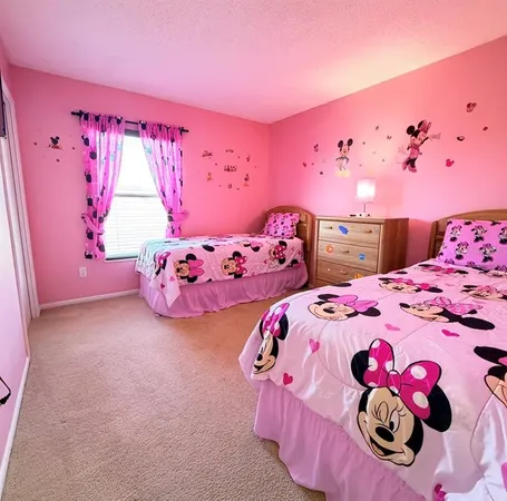 a bedroom with pink walls and pink umbrellas
