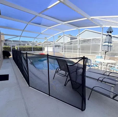a view of a backyard with table and chairs under an umbrella
