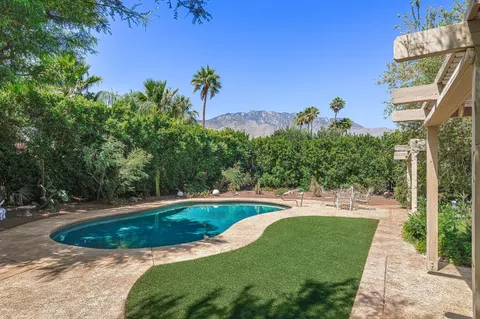 a view of a swimming pool with a yard