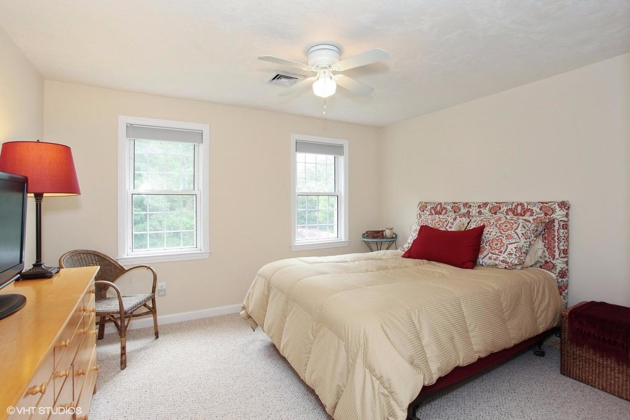 272 Cotuit Road Mashpee, MA 02649 - Photo 11 of 15 a bedroom with a bed and a large window