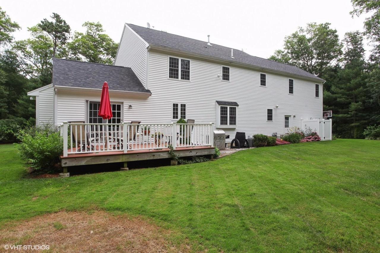 272 Cotuit Road Mashpee, MA 02649 - Photo 14 of 15 a view of a house with a backyard and deck