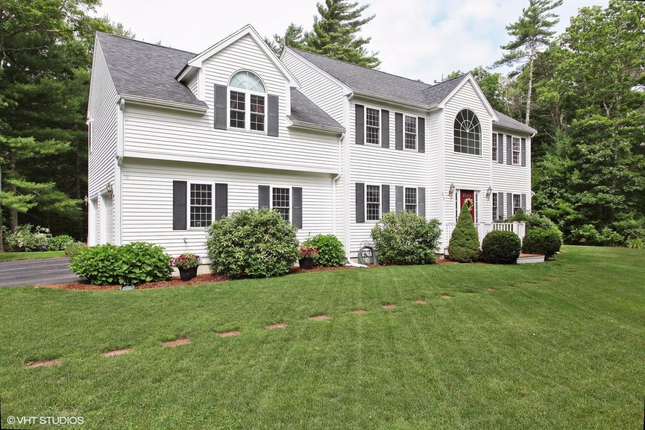 272 Cotuit Road Mashpee, MA 02649 - Photo 15 of 15 a front view of a house with a yard and trees