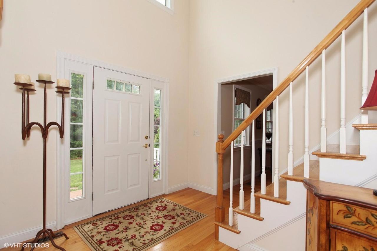 272 Cotuit Road Mashpee, MA 02649 - Photo 2 of 15 a view of hallway with wooden floor and stairs