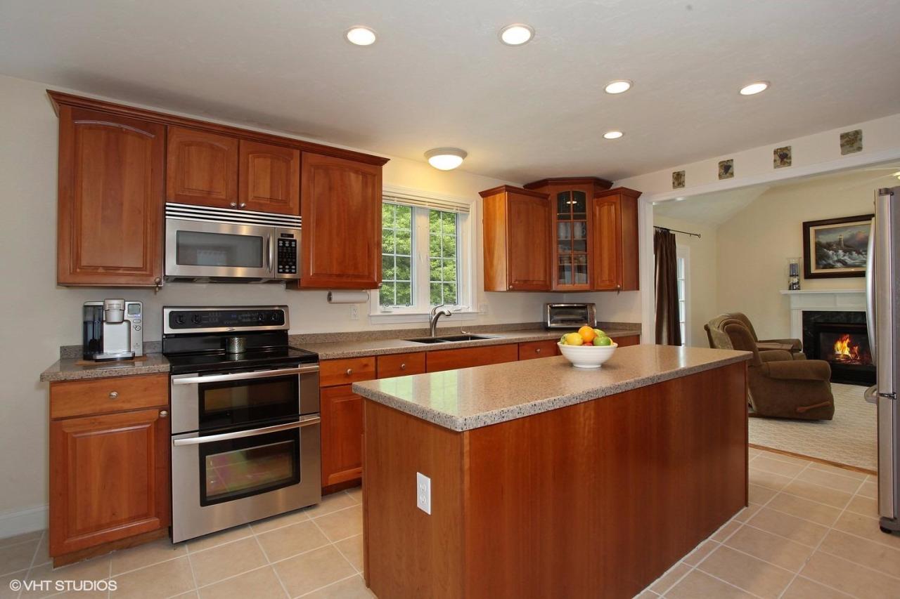 272 Cotuit Road Mashpee, MA 02649 - Photo 3 of 15 a kitchen with stainless steel appliances granite countertop a stove top oven a sink dishwasher and a microwave oven on the blue kitchen countertops