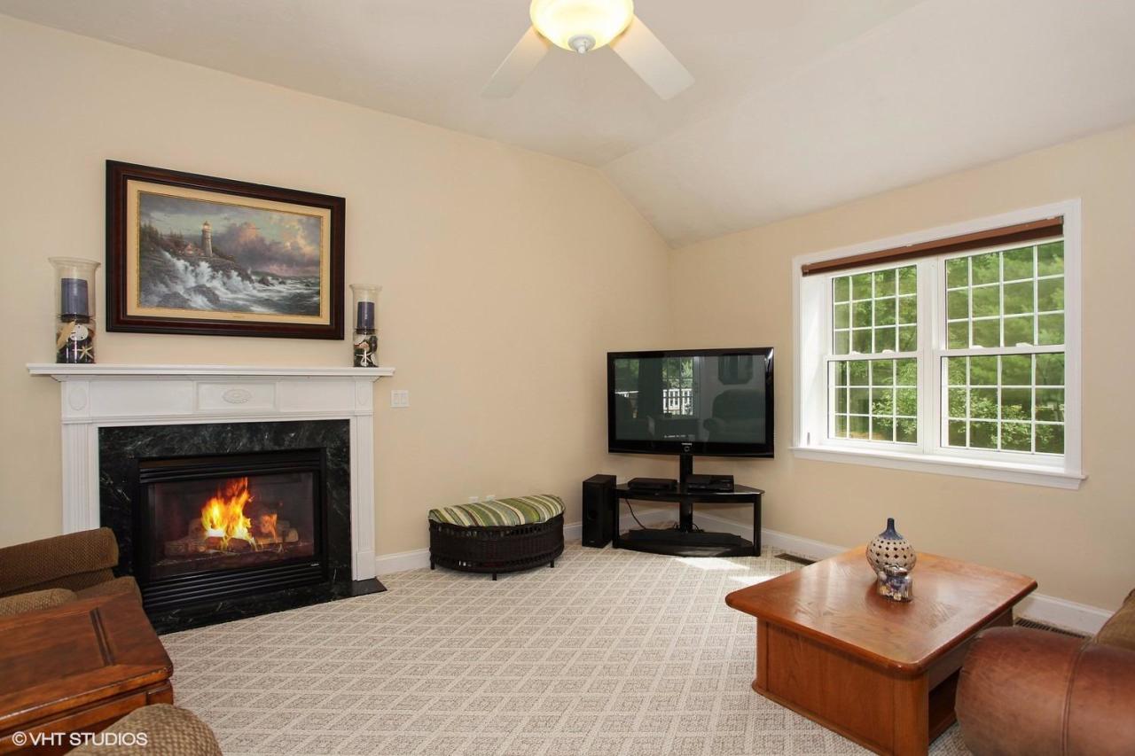 272 Cotuit Road Mashpee, MA 02649 - Photo 5 of 15 a living room with furniture a fireplace and a flat screen tv