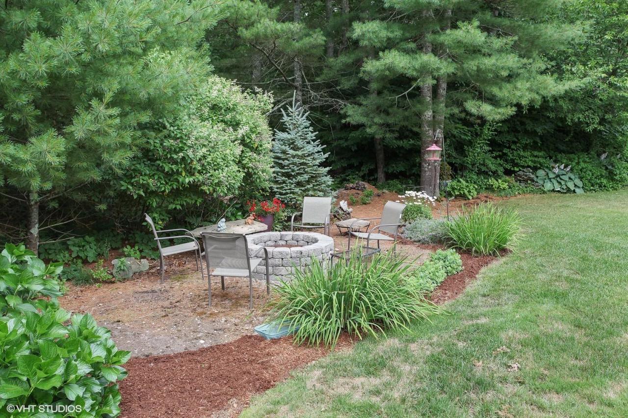 272 Cotuit Road Mashpee, MA 02649 - Photo 6 of 15 a view of a chair and table in the garden