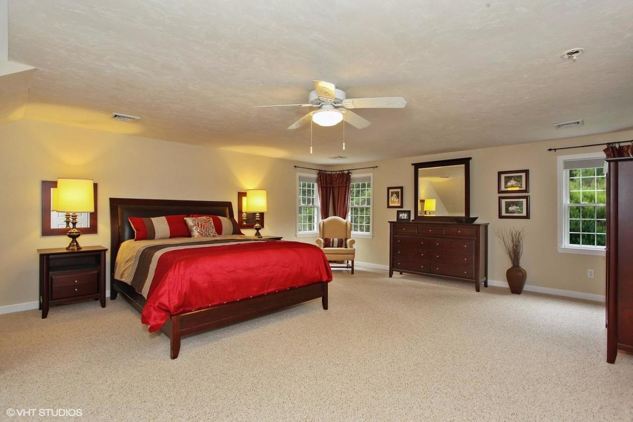 272 Cotuit Road Mashpee, MA 02649 - Photo 9 of 15 a spacious bedroom with a bed and a chandelier