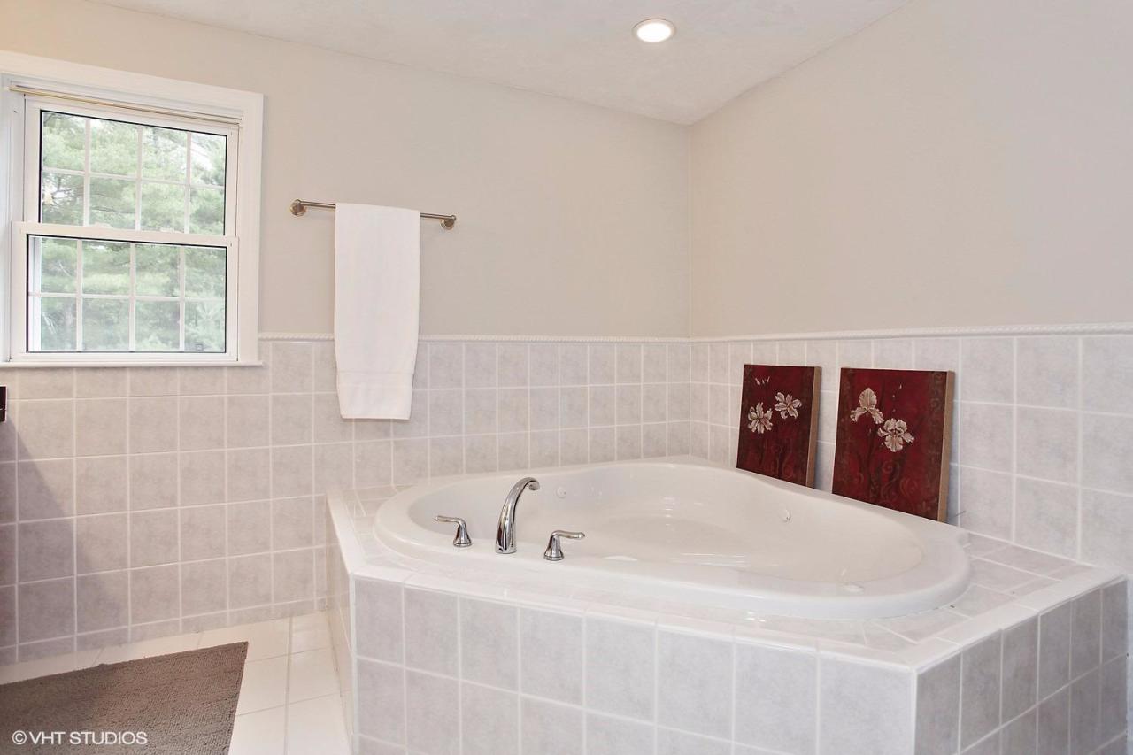 272 Cotuit Road Mashpee, MA 02649 - Photo 10 of 15 a bath tub sitting in a bathroom next to a window