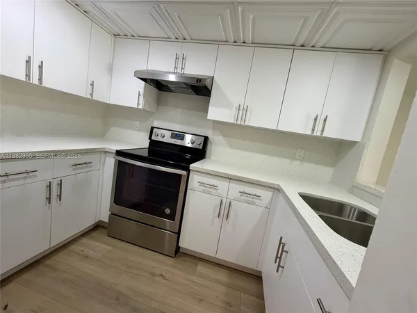 a kitchen with cabinets and appliances
