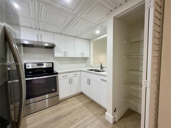 a kitchen with a stove and a refrigerator