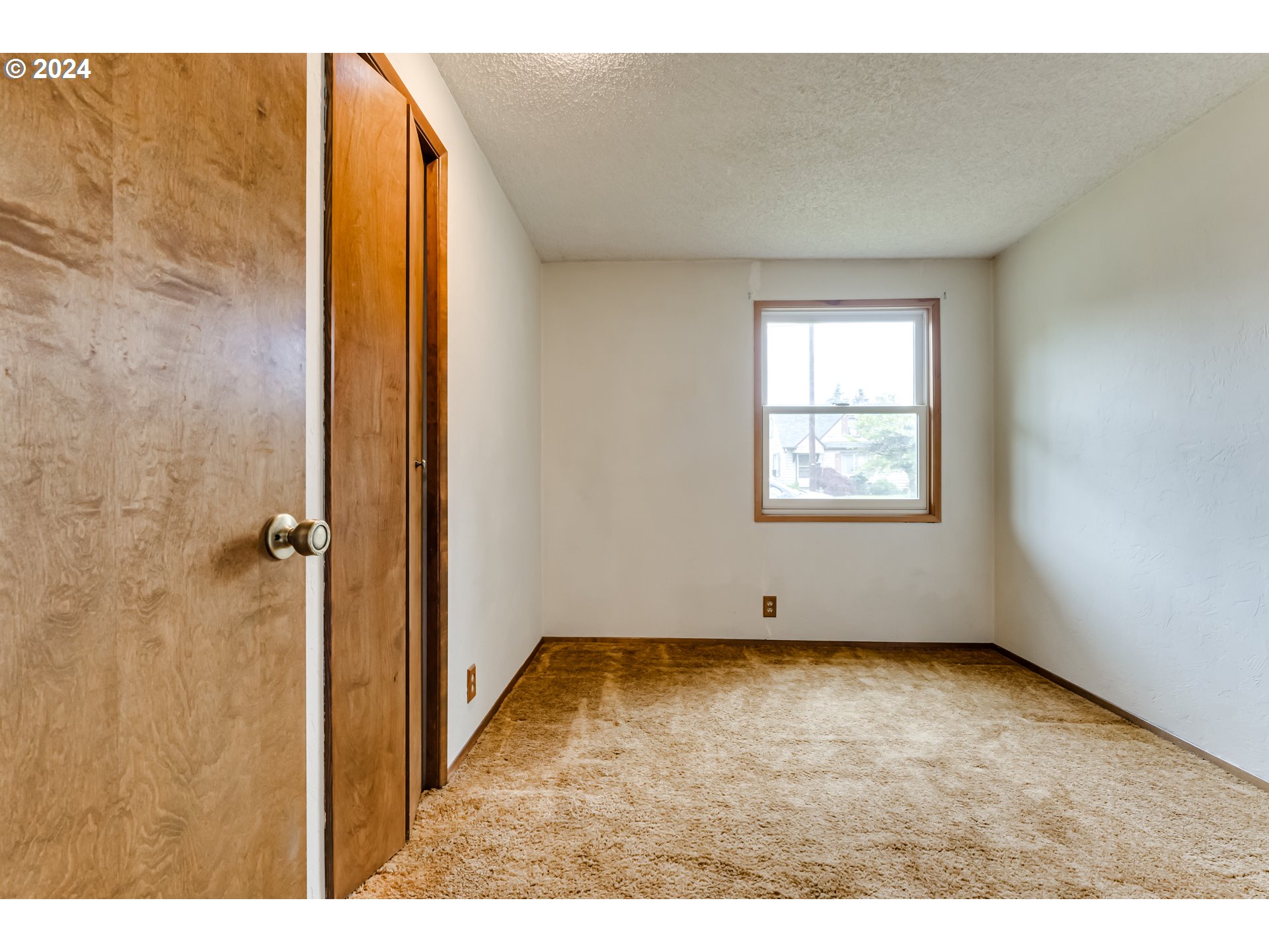 1038 5th Street Springfield, OR 97477 - Photo 12 of 26 an empty room with wooden floor and windows