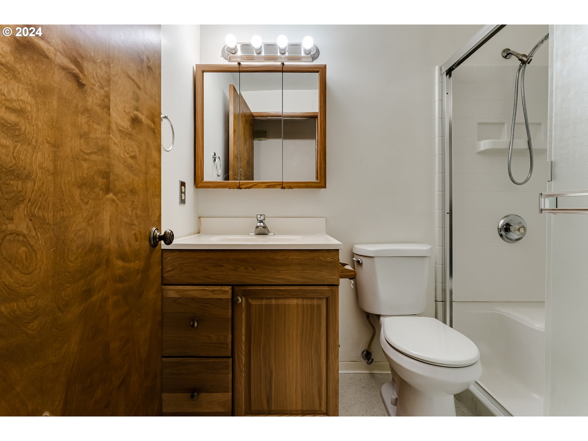 1038 5th Street Springfield, OR 97477 - Photo 13 of 26 a bathroom with a granite countertop toilet sink and mirror