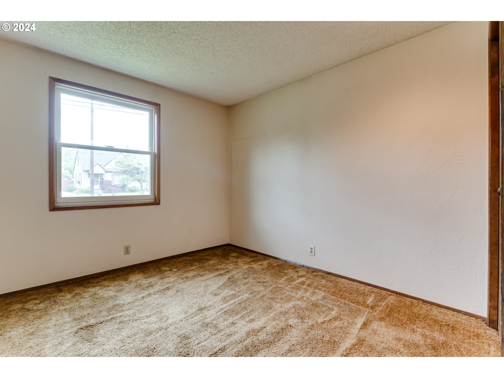 1038 5th Street Springfield, OR 97477 - Photo 17 of 26 an empty room with wooden floor and windows