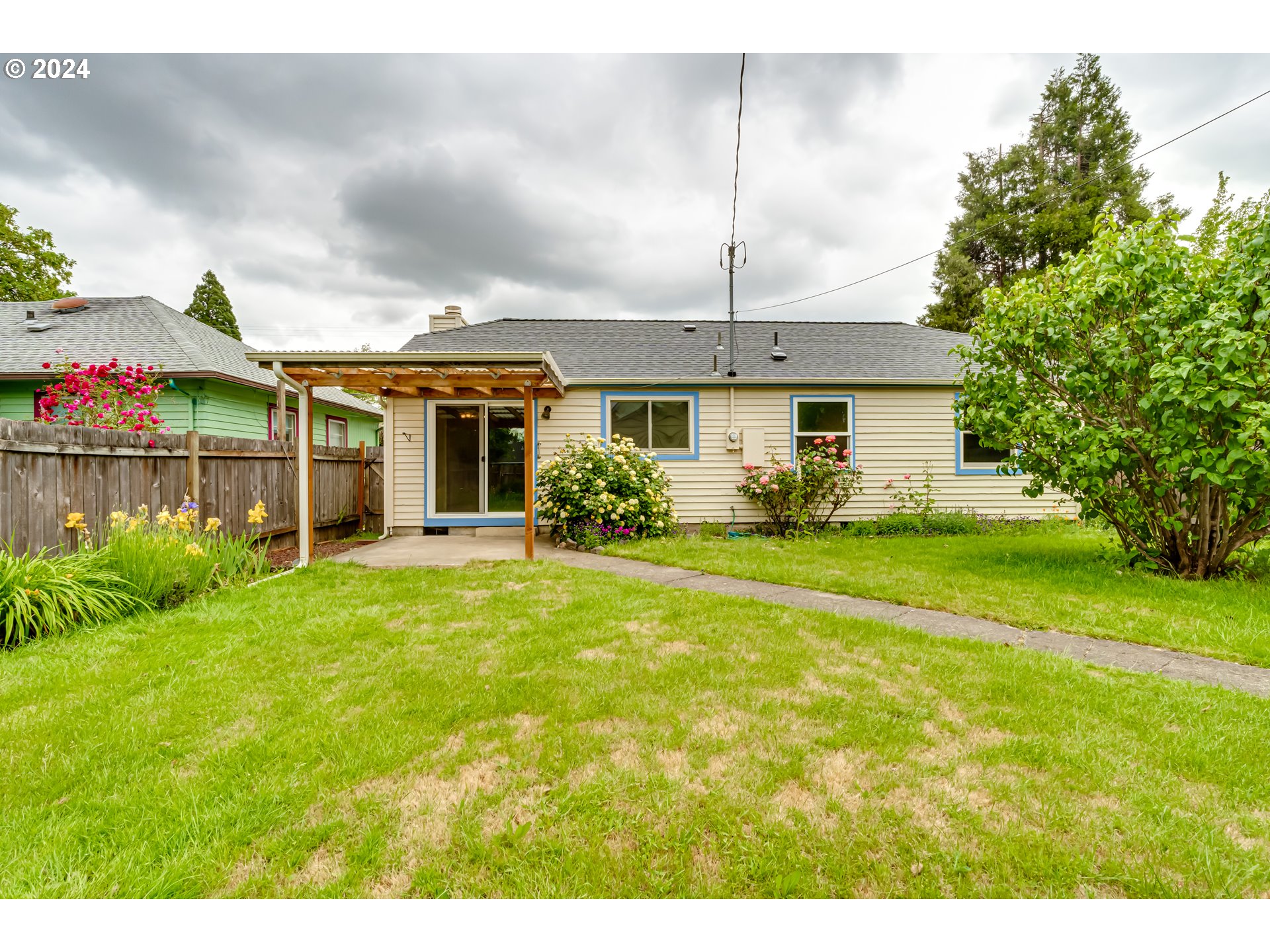 1038 5th Street Springfield, OR 97477 - Photo 21 of 26 a front view of a house with garden