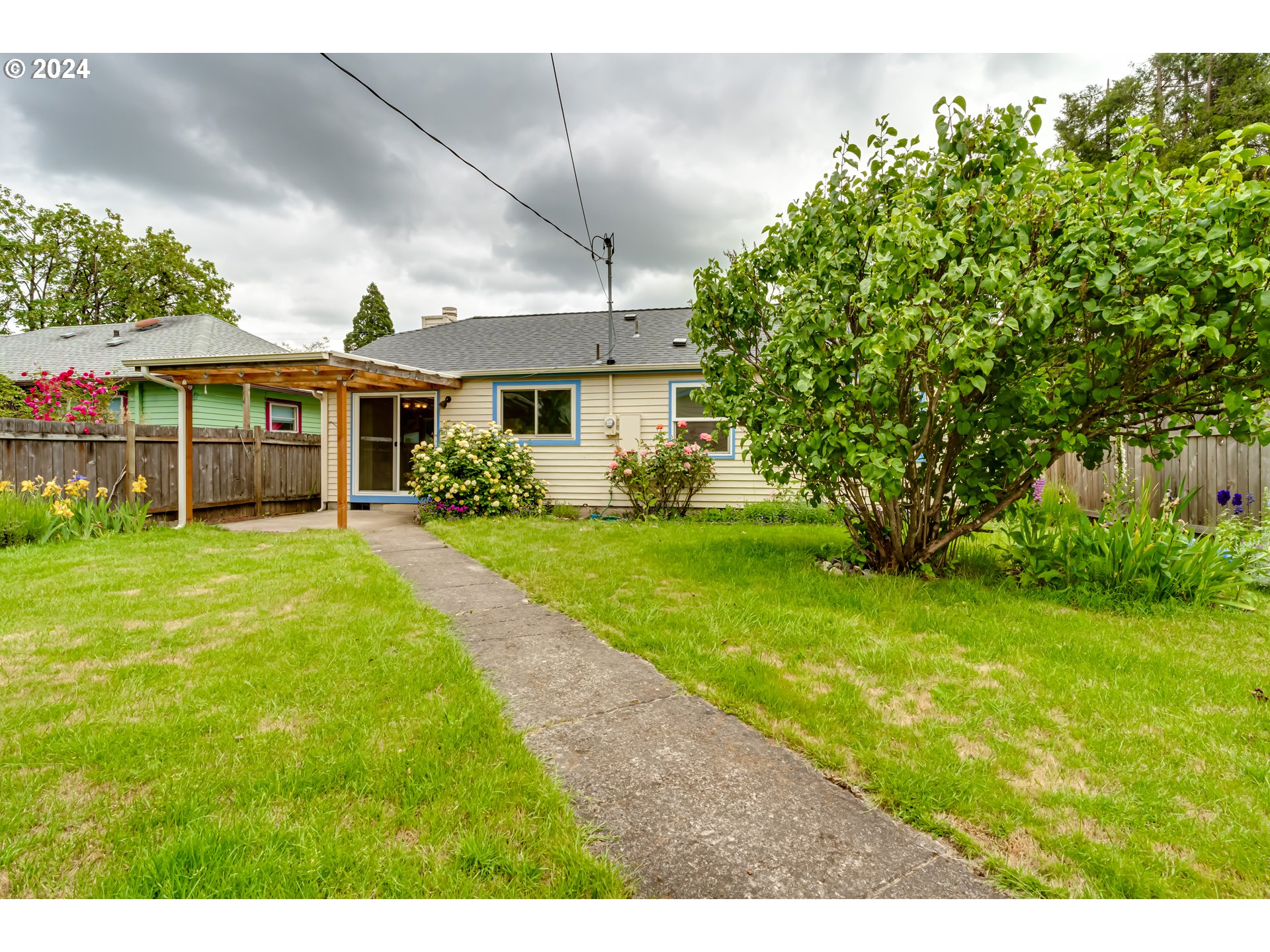1038 5th Street Springfield, OR 97477 - Photo 22 of 26 a very nice looking house with a big yard and large trees