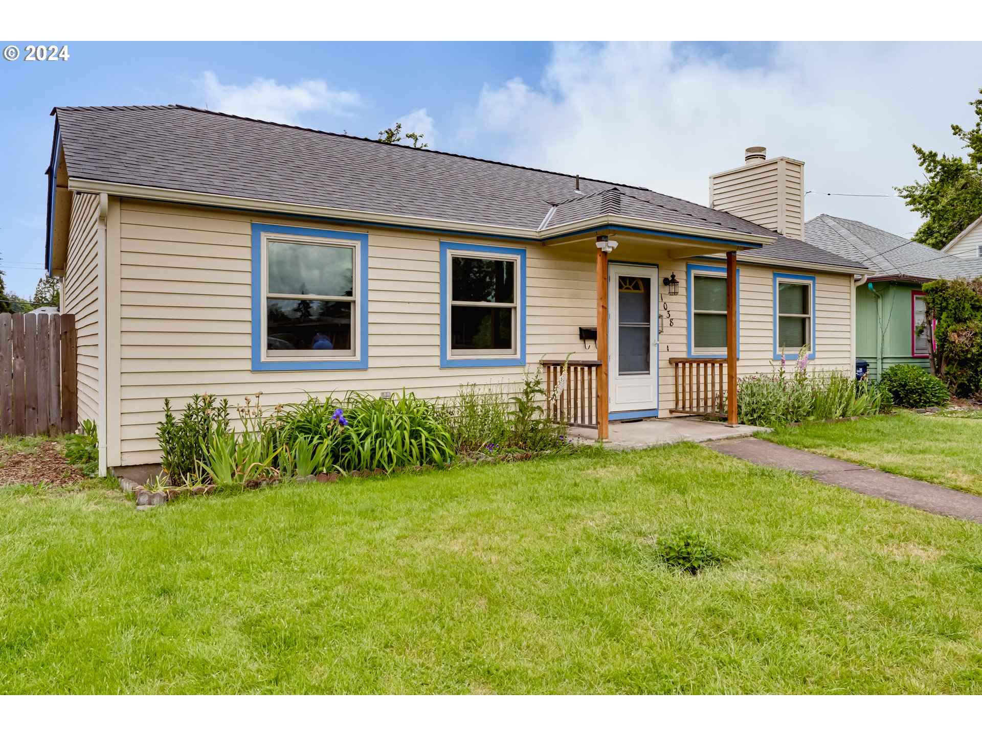 1038 5th Street Springfield, OR 97477 - Photo 3 of 26 a front view of a house with a yard