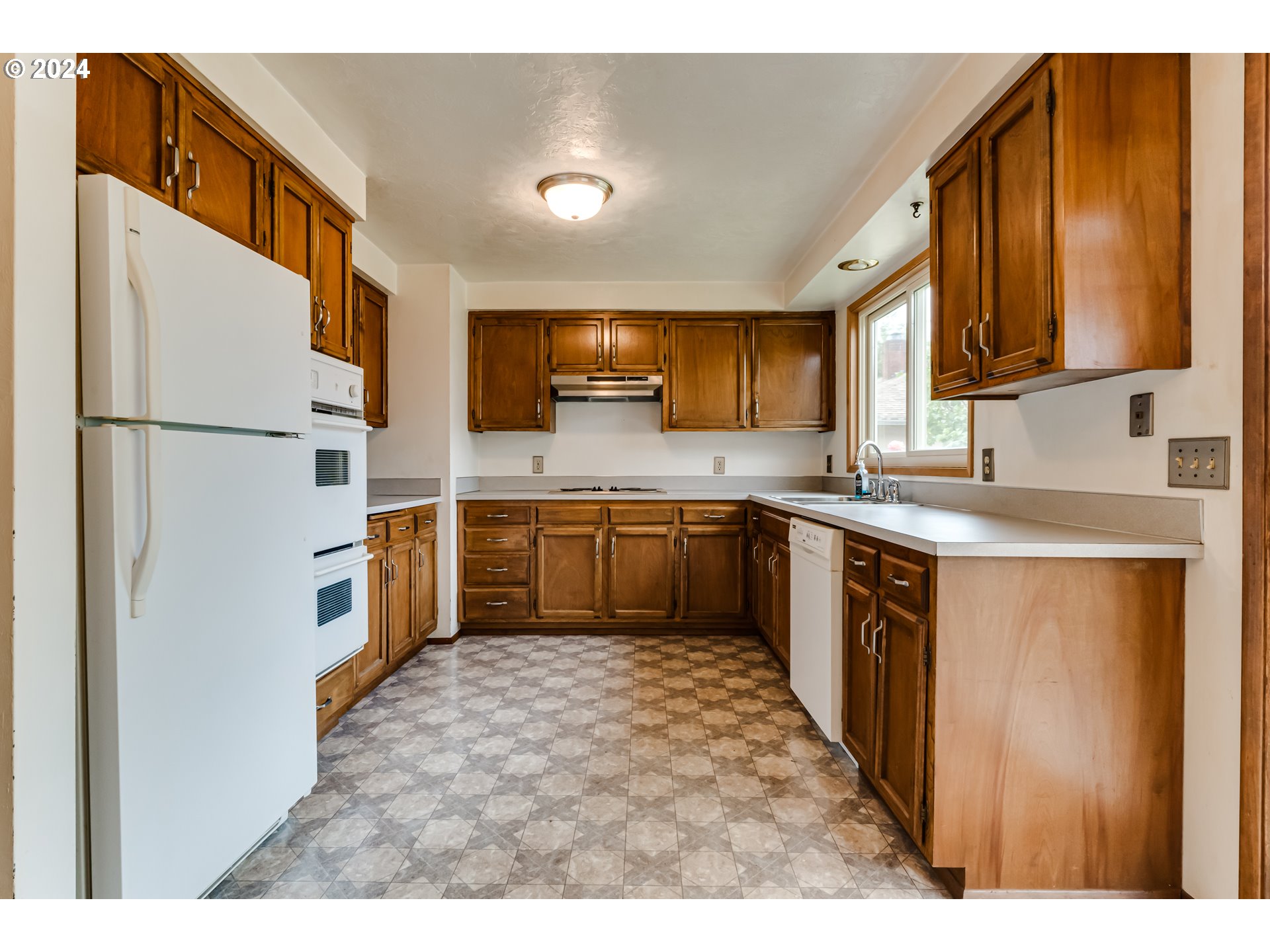 1038 5th Street Springfield, OR 97477 - Photo 8 of 26 a kitchen with cabinets stainless steel appliances and sink