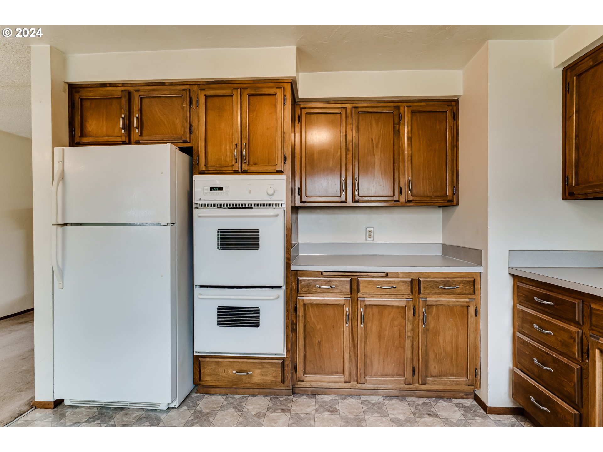1038 5th Street Springfield, OR 97477 - Photo 9 of 26 a kitchen with stainless steel appliances granite countertop a refrigerator and a stove top oven