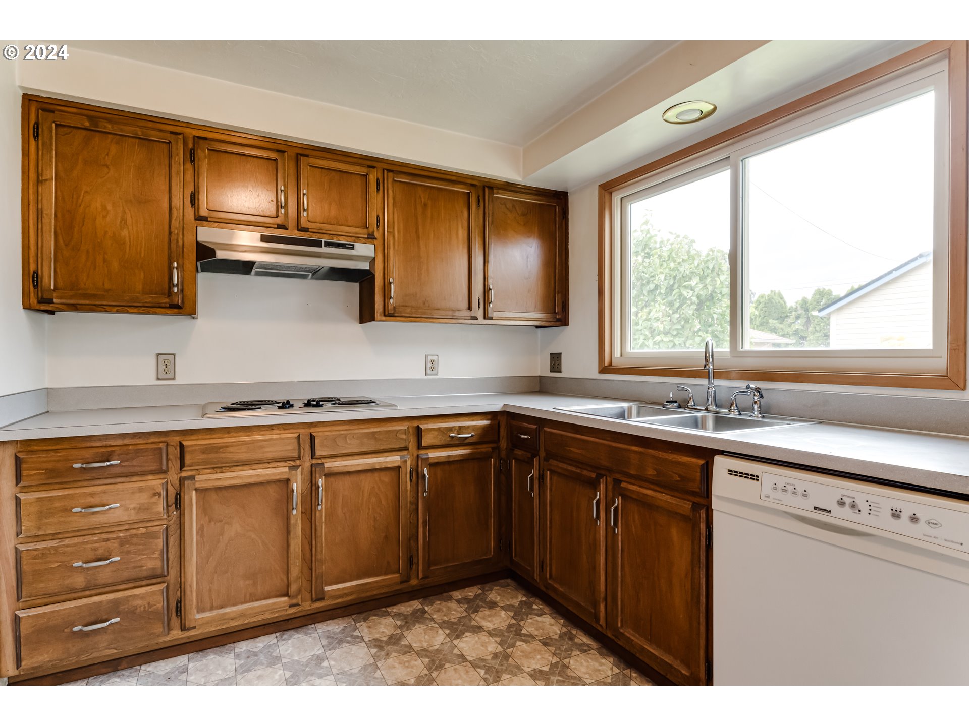 1038 5th Street Springfield, OR 97477 - Photo 10 of 26 a kitchen with stainless steel appliances granite countertop a sink window and cabinets