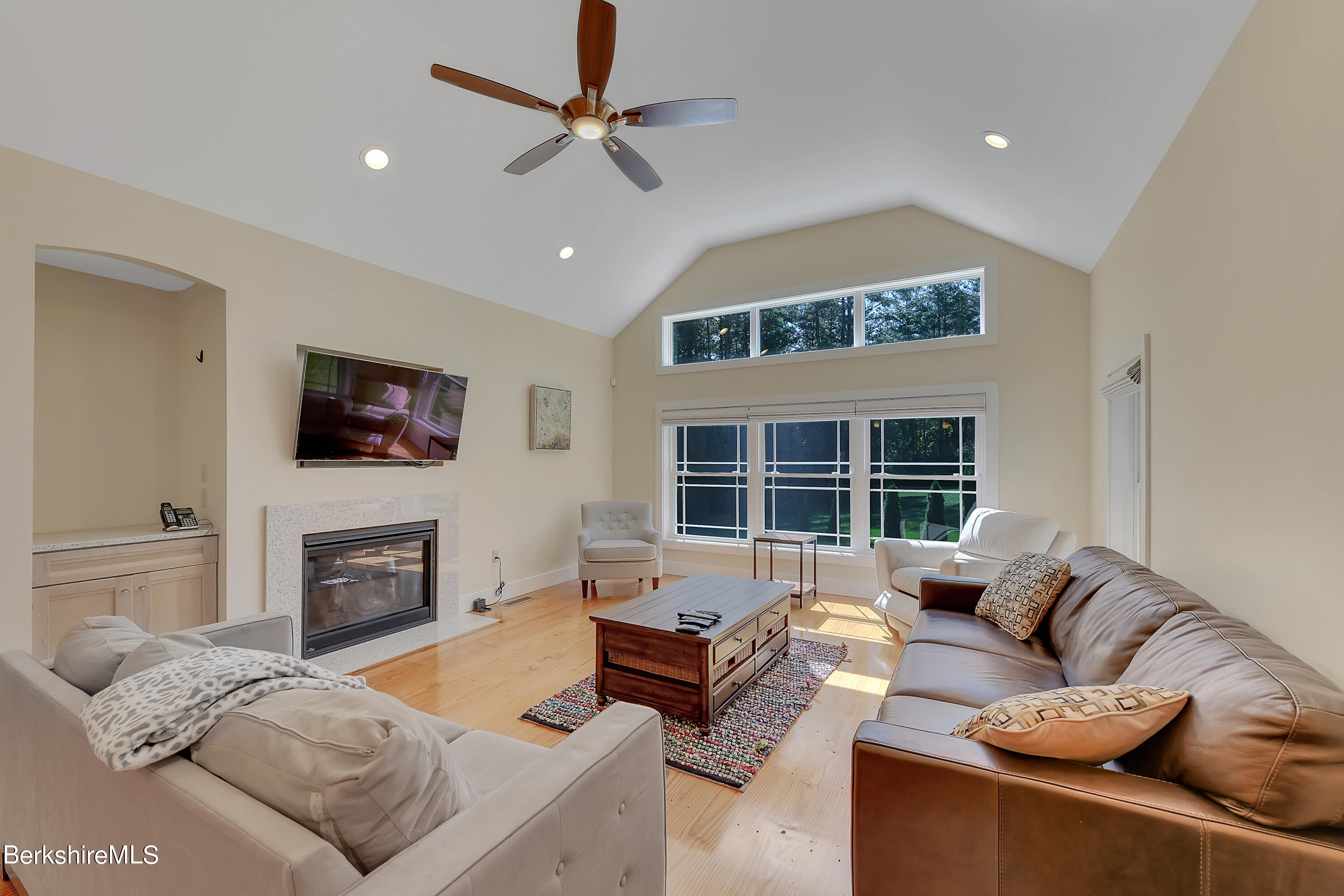 583 W Road Lee, MA 01238 - Photo 13 of 37 a living room with furniture a fireplace and a flat screen tv