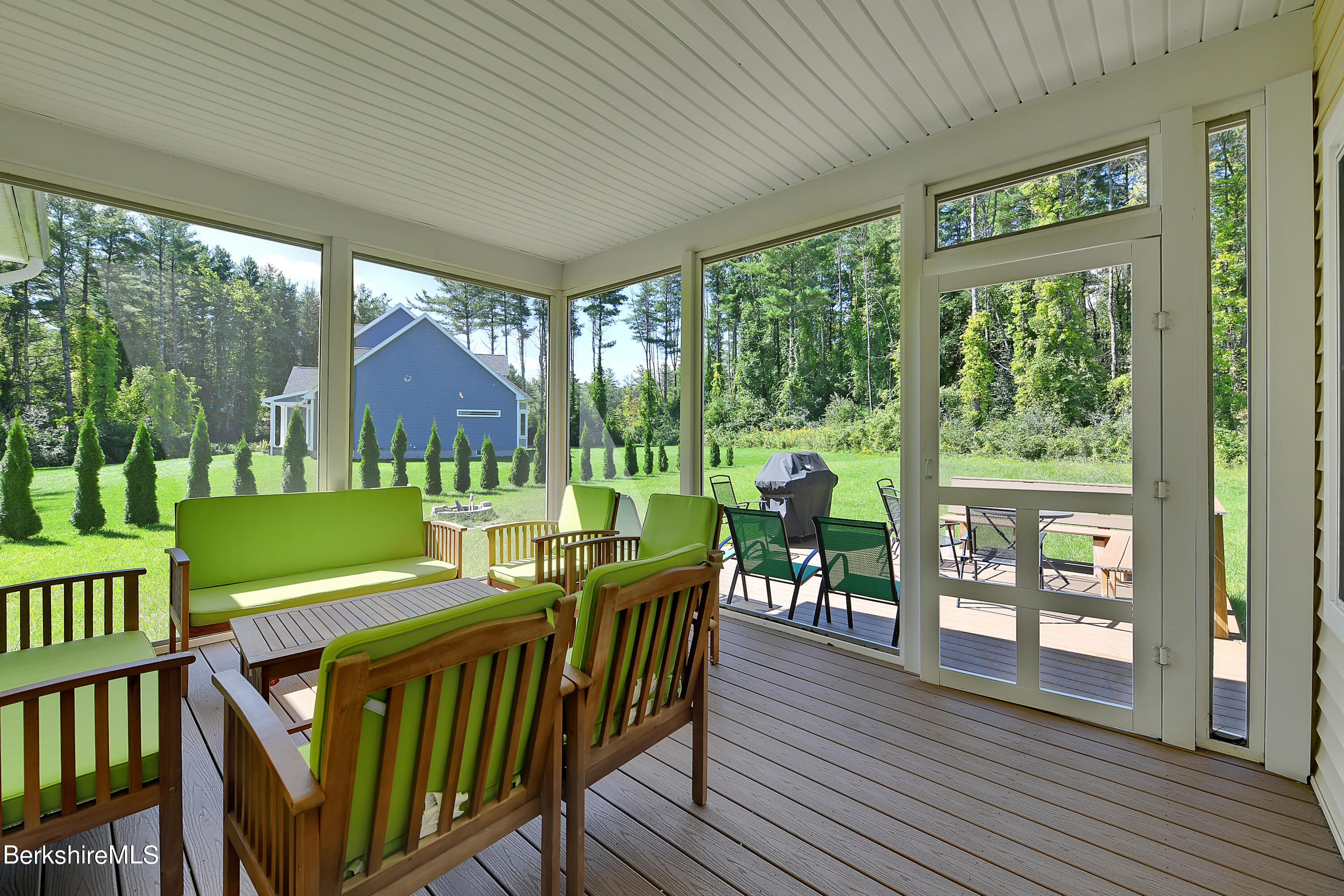 583 W Road Lee, MA 01238 - Photo 16 of 37 a view of a patio with a table chairs and a backyard